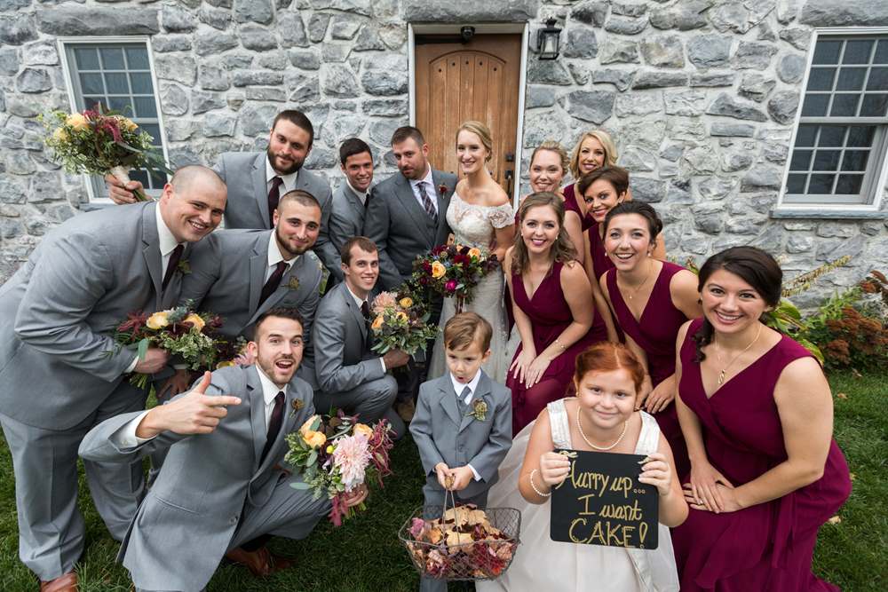 A wedding party in front of the Stone House at The Inn at Grace Farm in Fairfax, VT